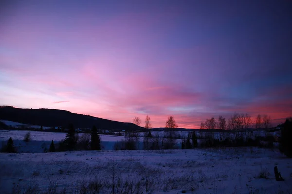 Sunset in the Ukrainian Carpathians. Winter in the village. Natu