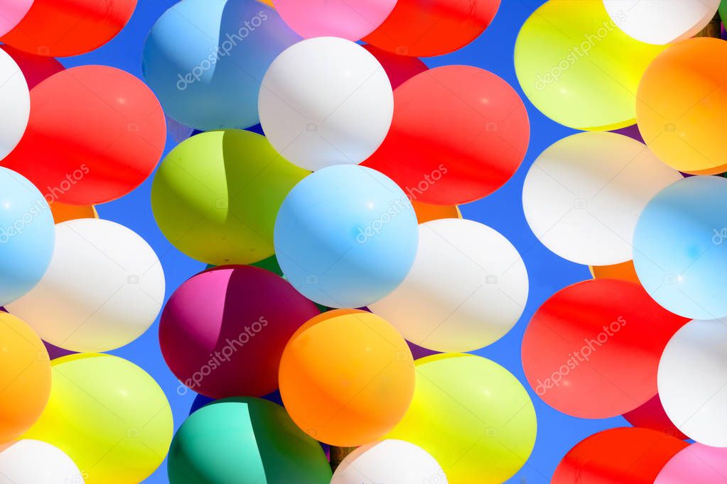 Group of colorful balloons on blue sky background