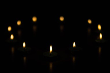 Candle flame on a dark background clipart