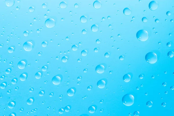 Water droplets on blue glass Royalty Free Stock Photos