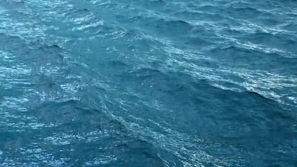 Fly over disturbed ocean water surface in slow motion — Stock Video