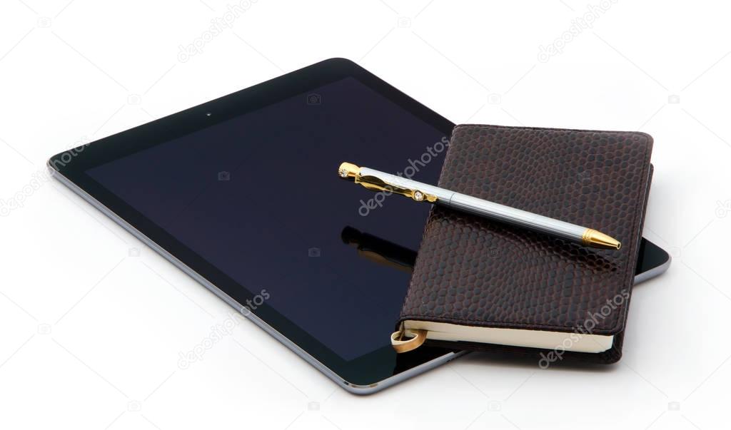 Tablet and Notepad of crocodile leather and expensive pen made of gold of silver with diamonds.
