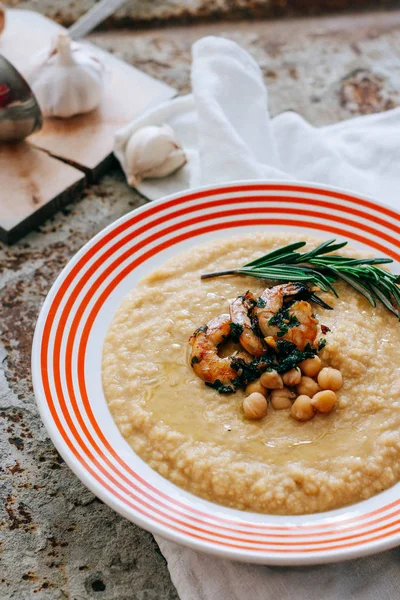 Chickpeas puree with garlic butter and shrimps