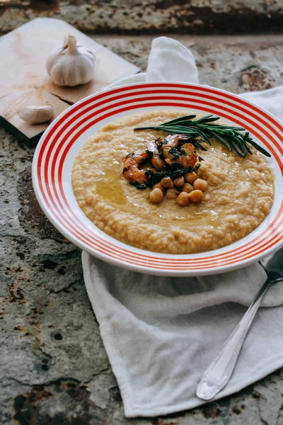 Chickpeas puree with garlic butter and shrimps