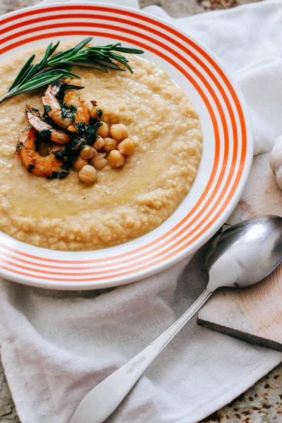 Chickpeas puree with garlic butter and shrimps