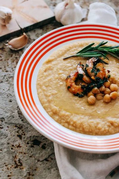 Chickpeas puree with garlic butter and shrimps