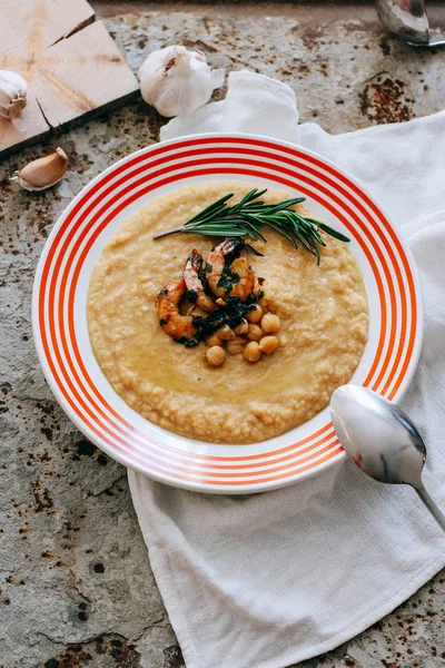 Chickpeas puree with garlic butter and shrimps