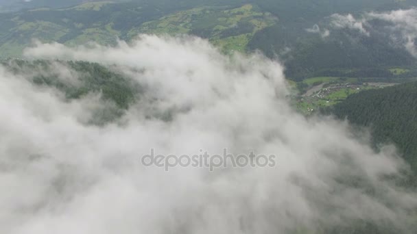 Aerial view of clouds over a mountain forest — Stock Video