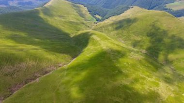 Flight over a green grassy mountains