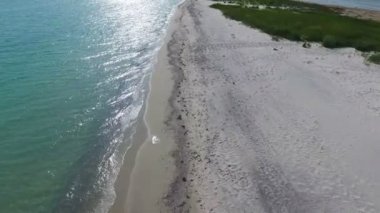 A bird`s eye view of the straight Black Sea sandy stripe with picturesque landscape and beautiful blue waters on a sunny day in summer. The narrow island looks emigmatic and picturesque