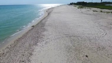 A bird`s eye view of the horizonless Black Sea sandy stripe with wonderful landscape and beautiful blue waters on a sunny day in summer. The yellow shore looks splendid at golden sunset