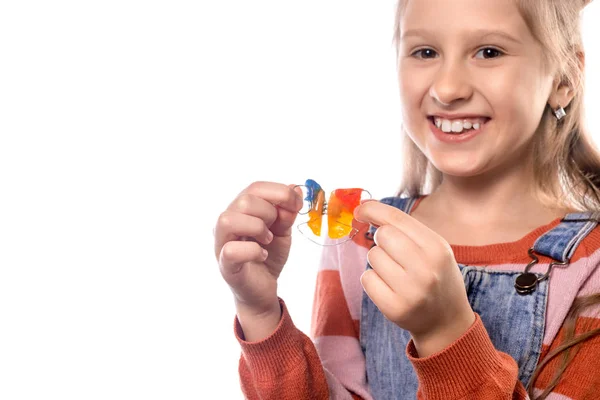 Ortodonti aletli küçük kız beyaz sırt çantasında izole edilmiş.
