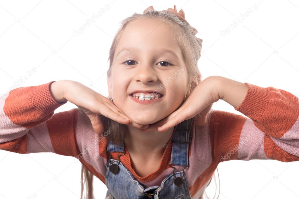 Portrait of little girl with orthodontics appliance isolated on white background.