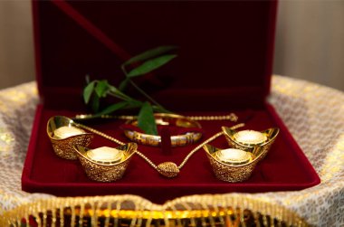 Gold Sycees or yuanbao (gold ingot, symbol of wealth and prosperity), Gold Lace, Gold Necklace used as wedding dowry in Traditional Chinese marriage and engagement ceremony. Wedding Ceremony Customs. clipart