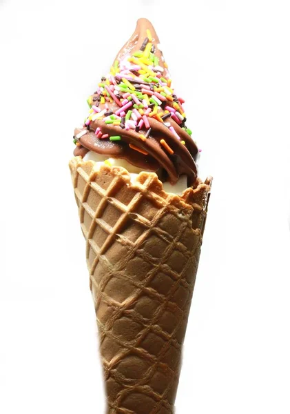 Soft serve ice cream in a cone with topping — Stock Photo, Image