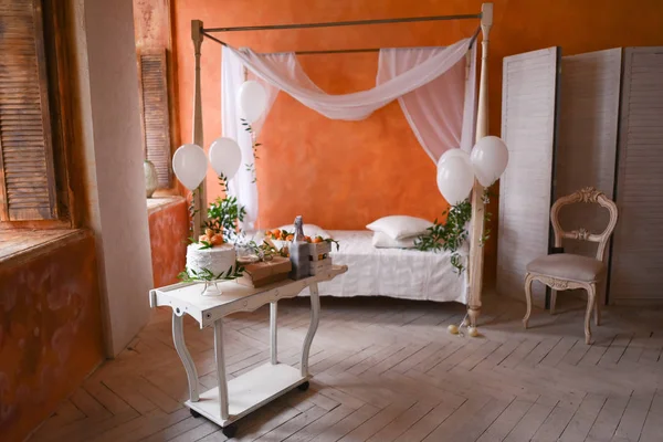 Gender reveal cake on baby shower party in room design moroccan style with orange walls and a canopy bed