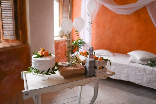 Gender reveal cake on baby shower party in room design moroccan style with orange walls and a canopy bed