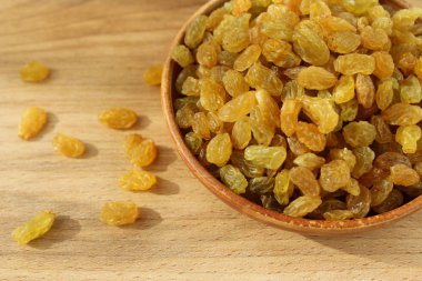 Bir tabak ve ahşap arka plan üzerinde altın üzüm