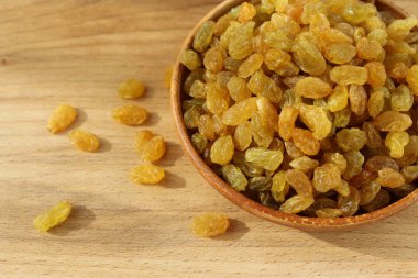 Bir tabak ve ahşap arka plan üzerinde altın üzüm