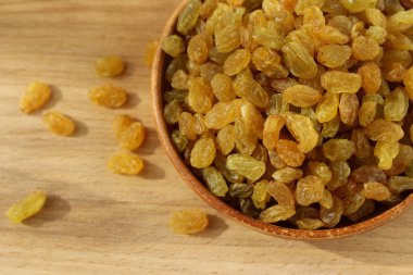 Bir tabak ve ahşap arka plan üzerinde altın üzüm