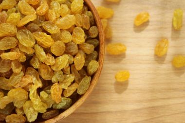 Bir tabak ve ahşap arka plan üzerinde altın üzüm