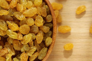 Bir tabak ve ahşap arka plan üzerinde altın üzüm