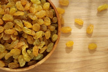 Bir tabak ve ahşap arka plan üzerinde altın üzüm