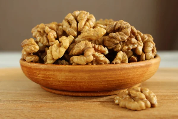 Walnut on the plate is a wooden Board — Stock Photo, Image