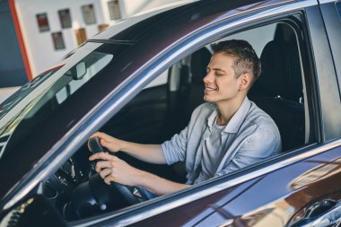 Caucasian man sitting in a new car.