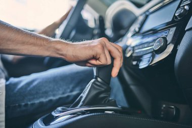 Close up male hand holding a transmission before purchasing a ne