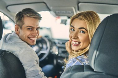 Smiling man and cheerful girl having fun and getting ready to dr