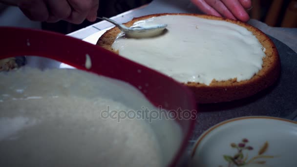 Panadero de la torta 4K adición de crema a la esponja al horno — Vídeo de stock