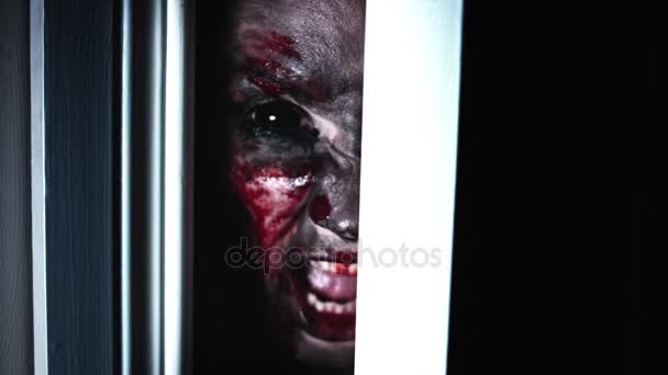 4K orrore sanguinante spaventoso donna occhio guardando in porta lacuna e urlando — Video Stock