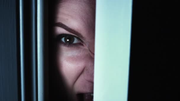 4K Thriller mujer ojo mirando en puerta agujero brecha y gritando — Vídeos de Stock