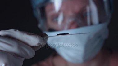 Bilim adamı inceleyerek kan testi