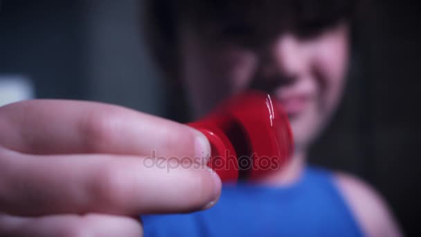 A fidget spinner is a toy that is marketed as relieving stress. It consists of a bearing in the center of a multi-lobed flat structure made from metal or plastic. — Stock Video