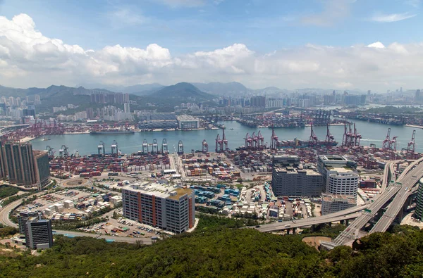 Container port Hong Kong harbor with cargo ships against city