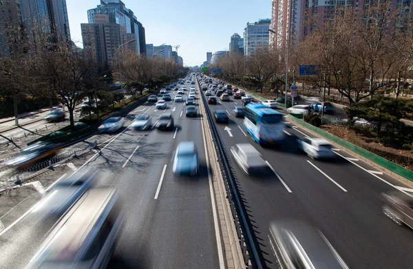 Chinese autos drive along wide Beijing street 