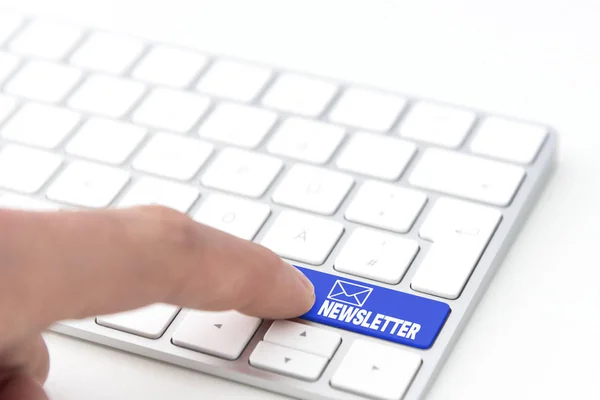 finger pressing a blue key labeled NEWSLETTER with envelope symbol on a computer keyboard concept