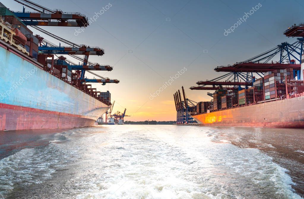 large container ships in harbor unter beautiful sunset sky