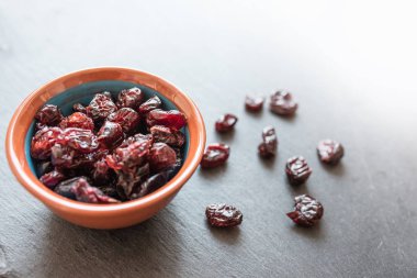 dried cranberries in bowl on slate