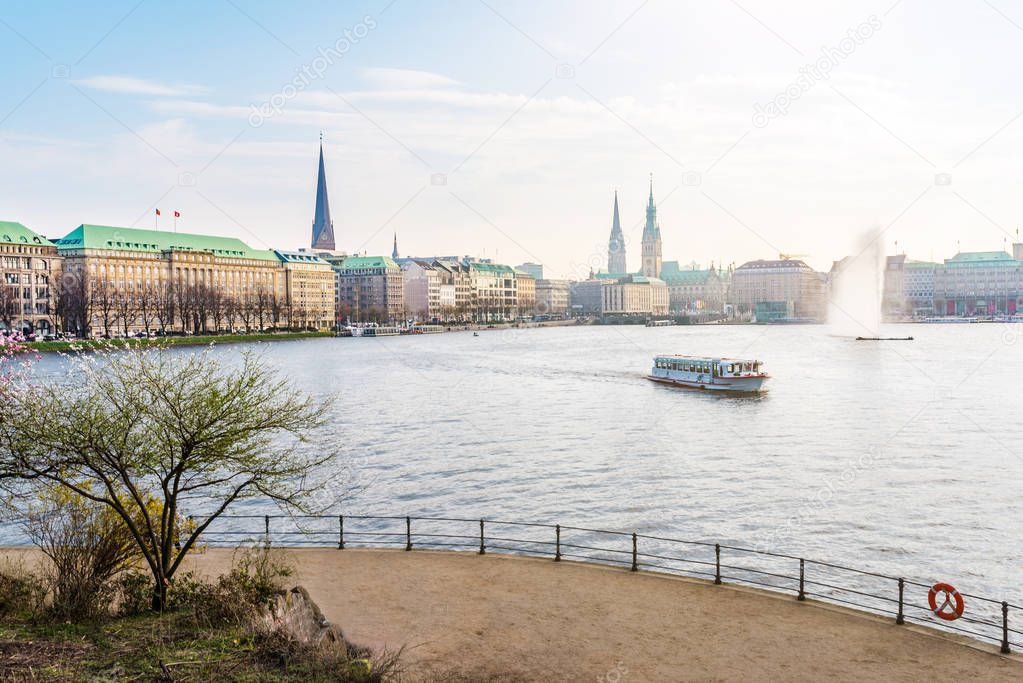 Alster Lake in Hamburg with Jungfernstieg and townhall in background on sunny spring day