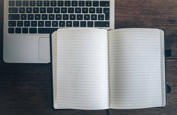 Empty open notepad on rustic wooden table with laptop computer — Stock Photo, Image