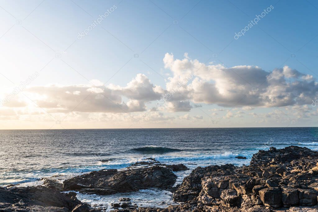rocky shore against ocean and beautiful sky