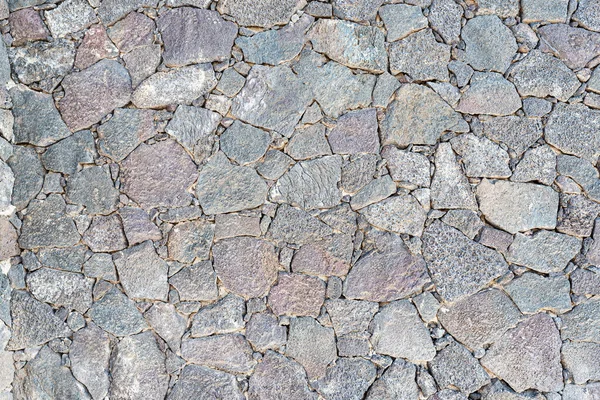Close-up van oneffen droge stenen muur achtergrond — Stockfoto