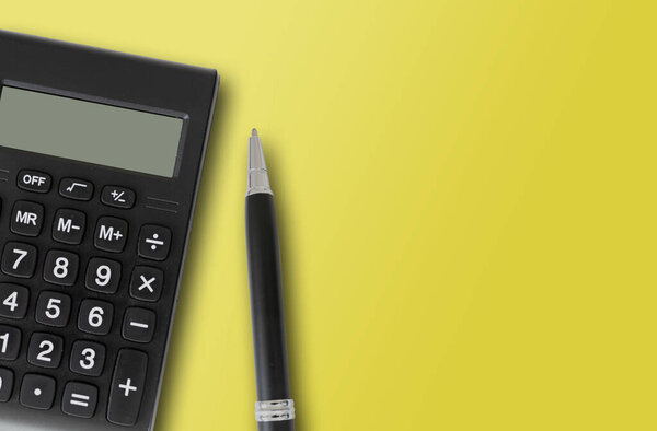 pocket calculator and pen on yellow background, finance and accounting concept