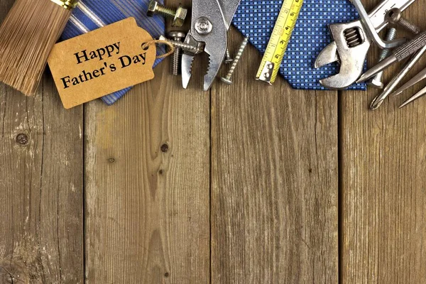 Happy Fathers Day gift tag with top border of tools and ties on wood