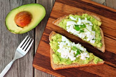 Yumurta akı ve bezelye ile avokado tost ahşap tahtaya vuruyor