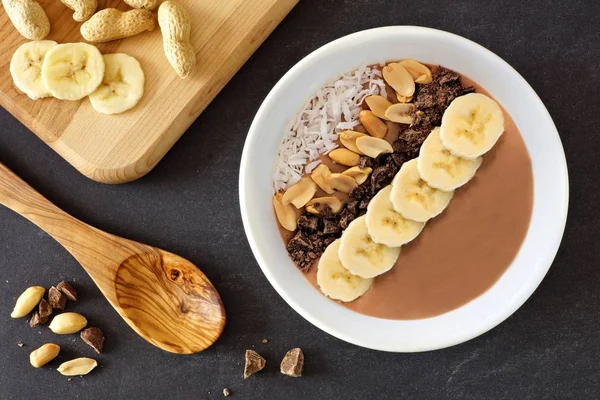 Chocolate peanut-butter banana smoothie bowl, over slate