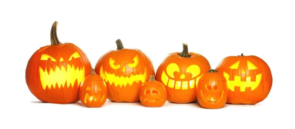 Row of lit Halloween Jack o Lanterns isolated on white — Stock Photo, Image